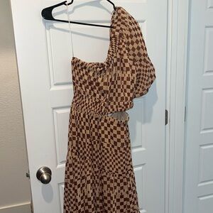Brown one shoulder check maxi dress.